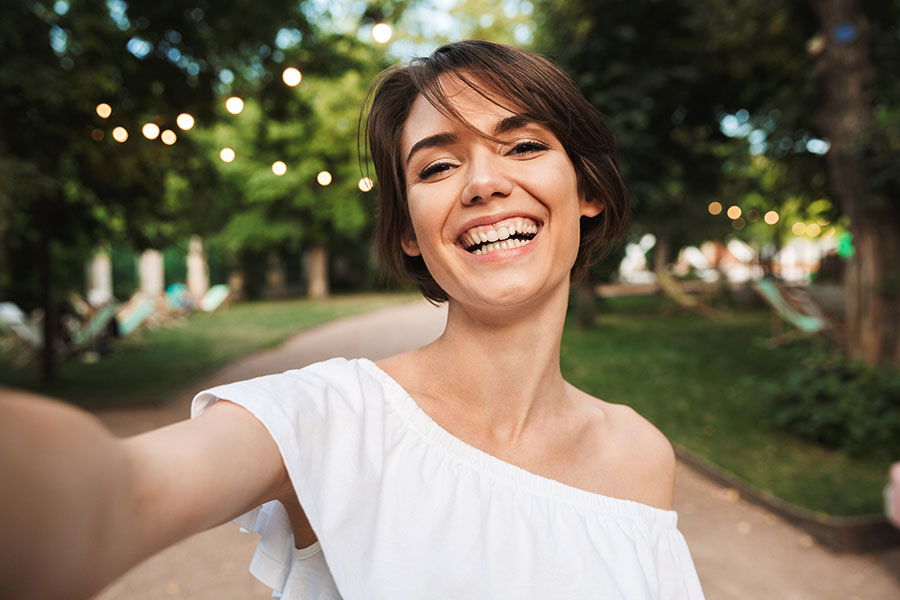 A woman is taking a selfie in a smiling face